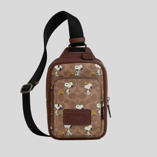 COACH Coach X Peanuts Racer Sling Pack In Signature Canvas With Snoopy Print Tan Multi CBK47