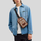 COACH Coach X Peanuts Racer Sling Pack In Signature Canvas With Snoopy Print Tan Multi CBK47