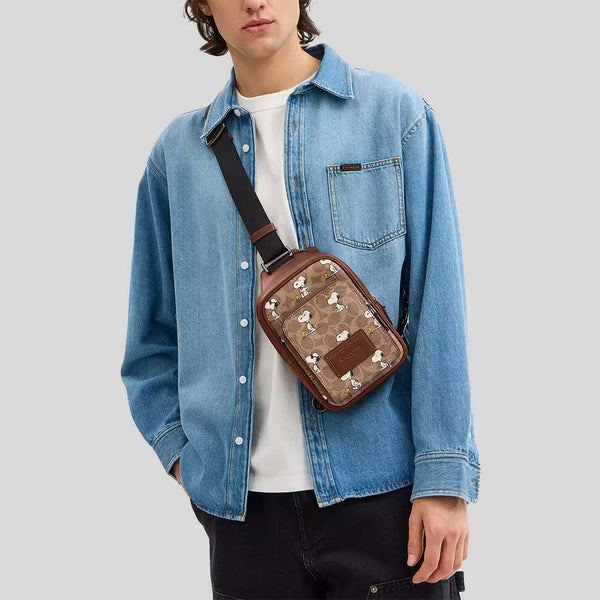 COACH Coach X Peanuts Racer Sling Pack In Signature Canvas With Snoopy Print Tan Multi CBK47