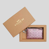 COACH Boxed Corner Zip Wristlet In Signature Canvas With Charms Pink/Rose CCK93