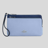 Blue Coach wristlet with a strap on a gray background