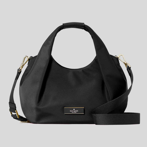 Black handbag with gold accents on a light gray background